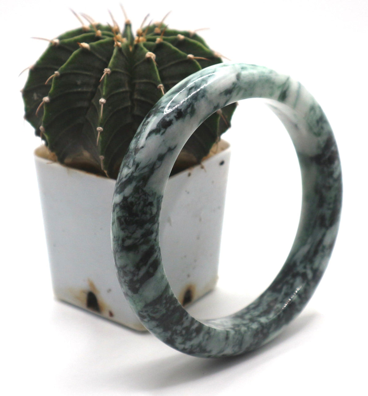 Green and white natural Jadeite bangle showing color variation