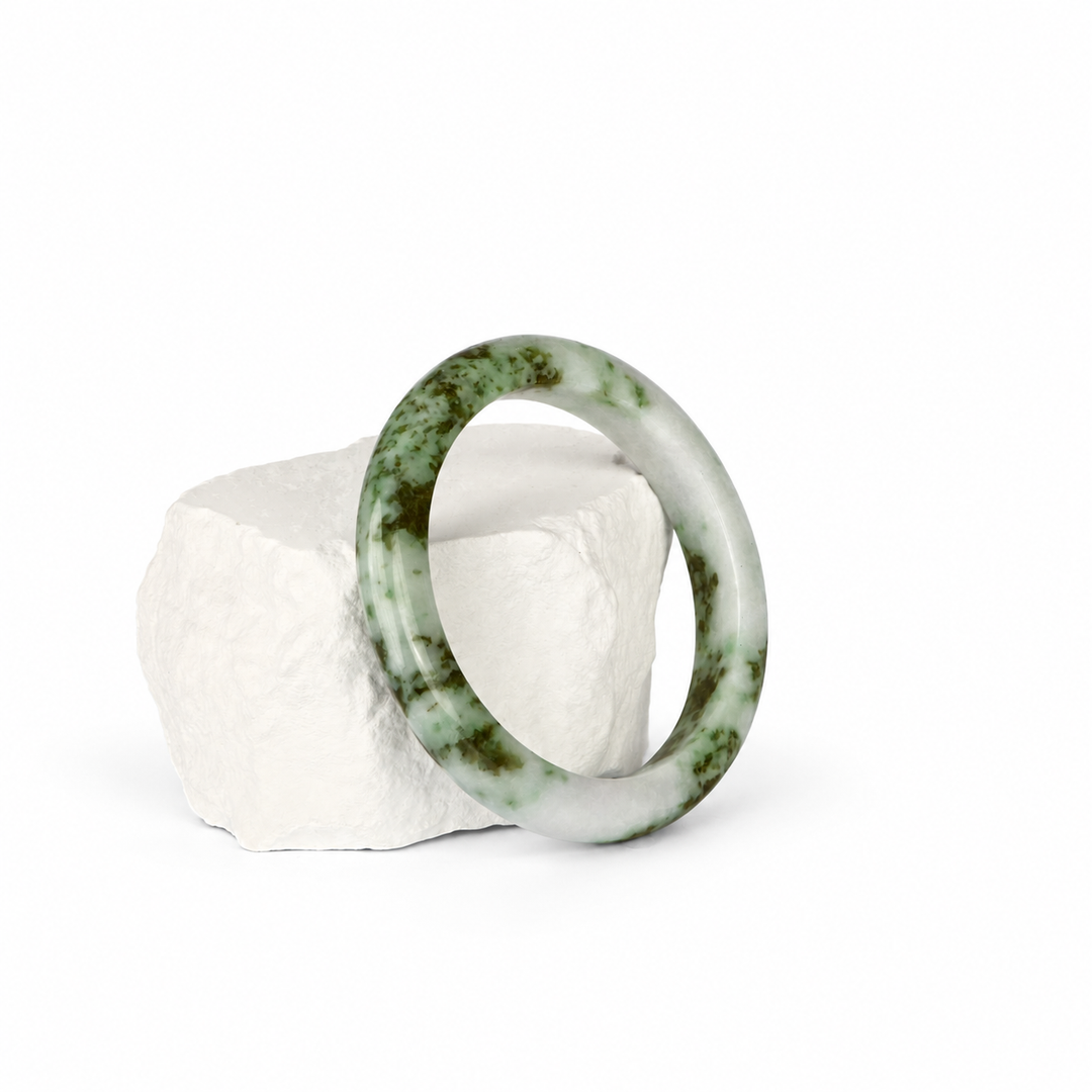 Moss-in-snow Jadeite bangle, hero view on white stone